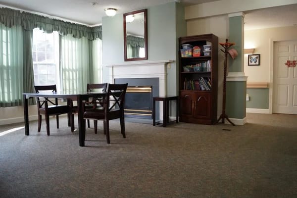 Cozy common area with a dining table and bookshelves