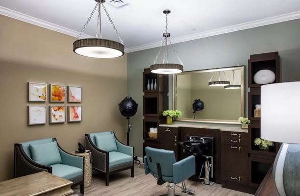 Hair salon area with styling chairs and artwork on the wall