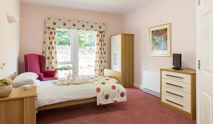 Cozy resident room with a bed and seating area