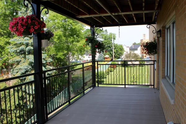 Covered patio area with plants and seating