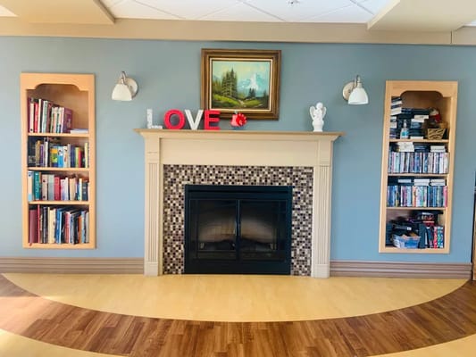 Common area with bookshelves and a fireplace