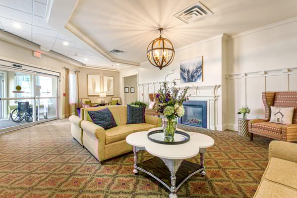 Bright and inviting living room with a cozy seating area and floral arrangement