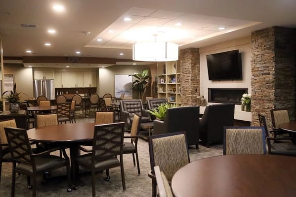 Spacious common area with tables and seating at St. Anthony’s Senior Living