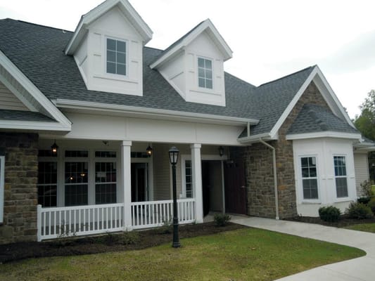 Front entrance of St. John's Home with a porch and landscaping