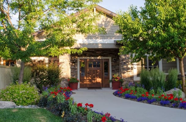 Welcoming main entrance with flower beds at St. John's United