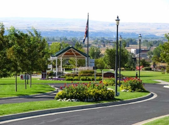 A well-maintained garden with a gazebo and flowers at St. John's United.