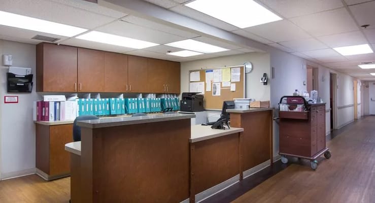 Reception area with a front desk and organizational materials.