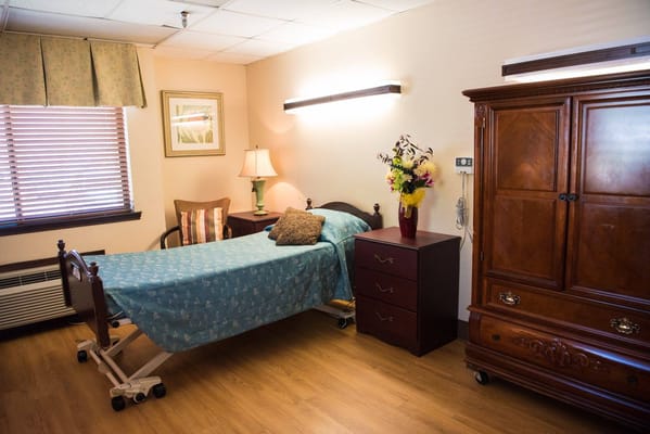 A well-furnished private resident room with a bed