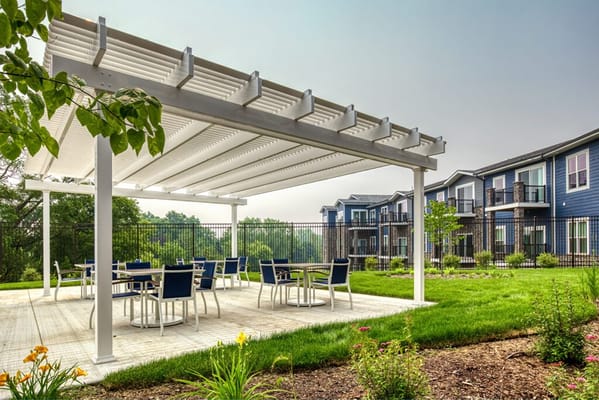 A covered outdoor patio with tables and chairs at Stair Crest.