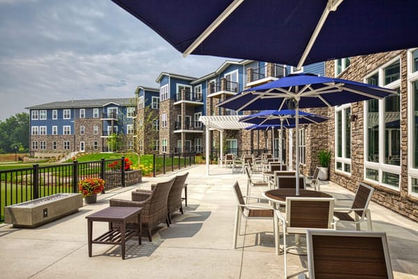 Outdoor patio with tables, chairs, and umbrellas at Stair Crest