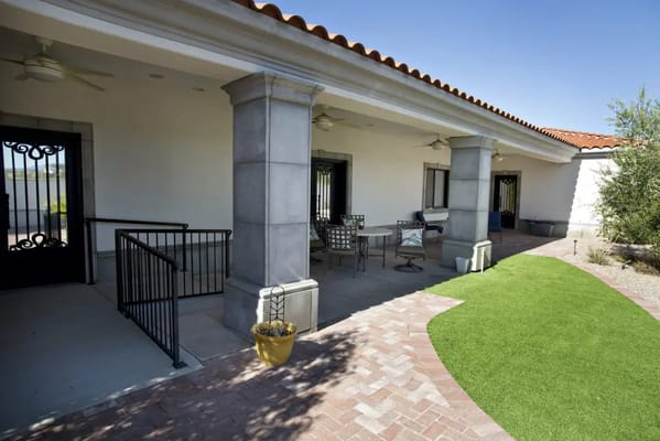 Outdoor seating area with tables and greenery