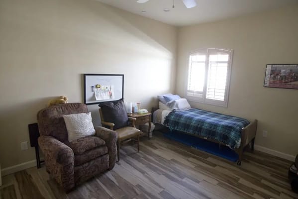 Cozy resident room with a bed and chair