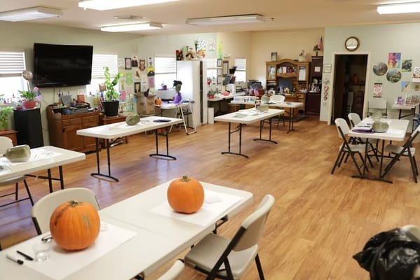 Activity room with tables, pumpkins, and decorations