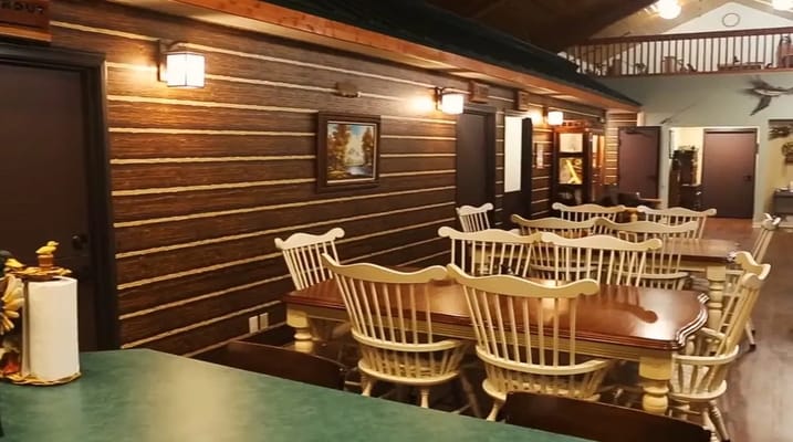Wooden dining area with white chairs