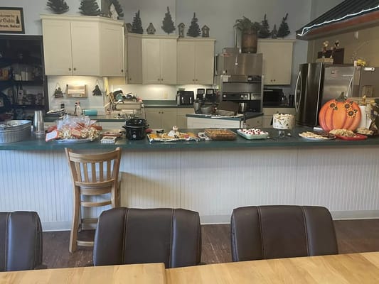 A kitchen counter filled with food and decorations, including a pumpkin.