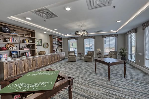 Bright and cozy common area with comfortable seating and shelves filled with books.