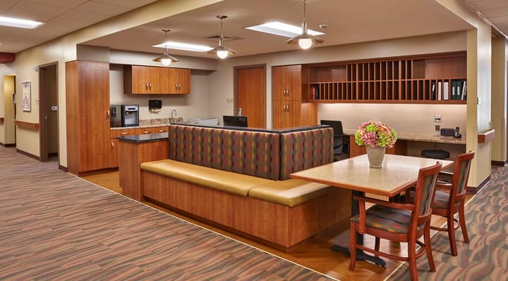 Cozy lounge area with seating and kitchenette in Stonecroft Health Campus