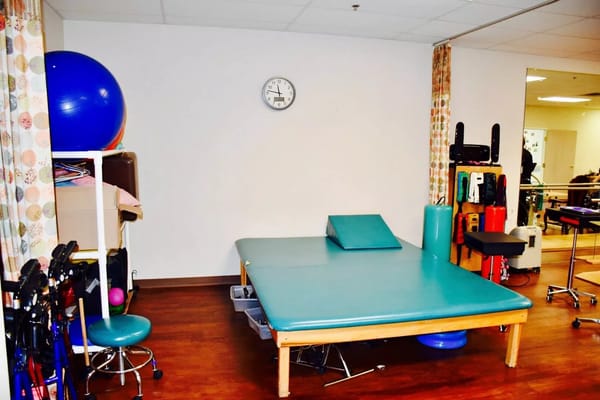 Interior of a therapy room with equipment at Stonegate Nursing and Rehabilitation.