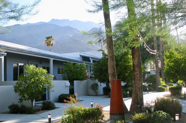 Outdoor area of Stonewall Gardens with desert landscape and mountains in the background.