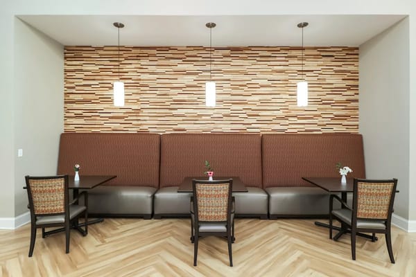 Cozy dining area featuring booths and tables with decorative lighting.