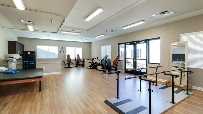 Interior view of a therapy room with exercise equipment