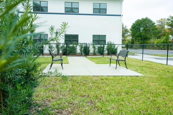 Outdoor seating area with benches and grass