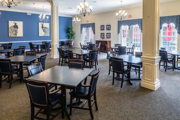 Spacious dining area with wooden tables and black chairs