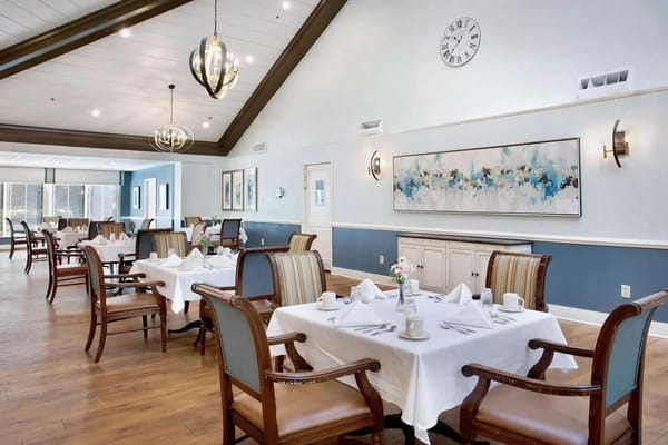 Bright dining room with tables set for meals