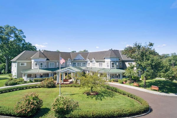 Exterior view of Sunrise at Fleetwood facility with gardens