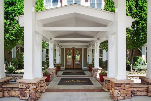 Entrance of Sunrise at Holladay with covered porch and landscaping