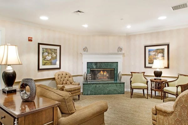 A cozy common area with comfortable seating and a fireplace