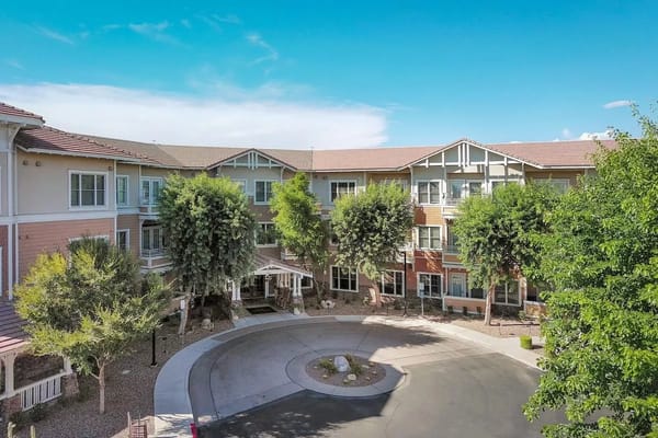 Exterior view of a senior living facility with landscaped areas
