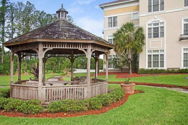 Gazebo in a landscaped garden area next to the building