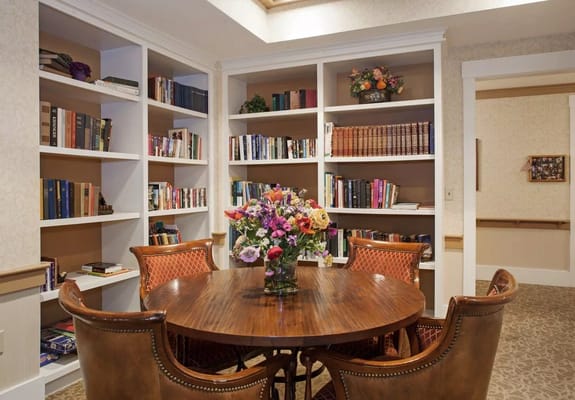 Cozy reading nook with bookshelves and flowers