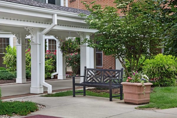Outdoor seating area with lush landscaping and flowers