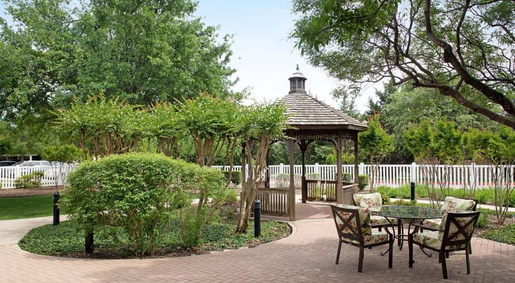 Gazebo surrounded by greenery and seating area