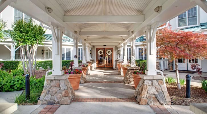 Entrance of a senior living facility with landscaped walkway