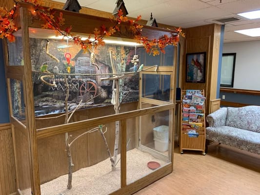 A bird habitat showcase in a facility common area.