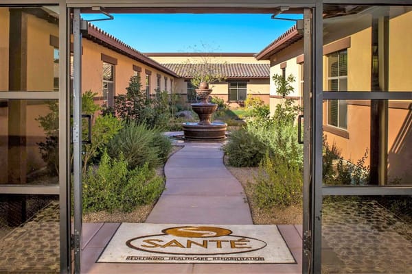 Entrance view into the landscaped courtyard with a fountain at Santé of Surprise.