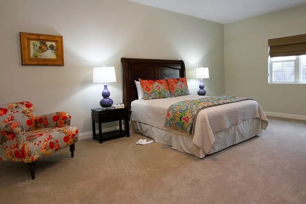 Comfortable bedroom with floral decor and lamps