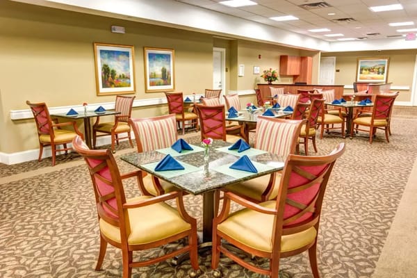 Dining table set with blue napkins in a cozy dining room
