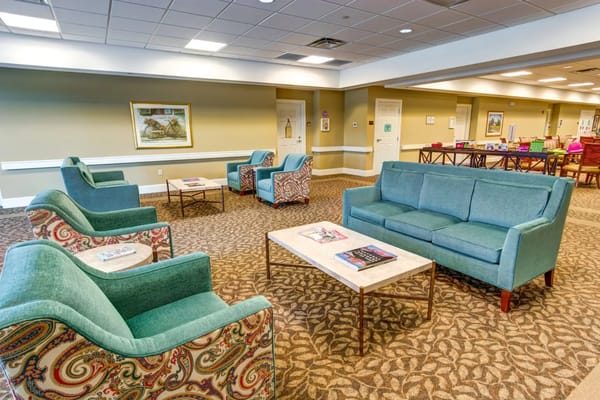 Lounge area with teal chairs and a coffee table