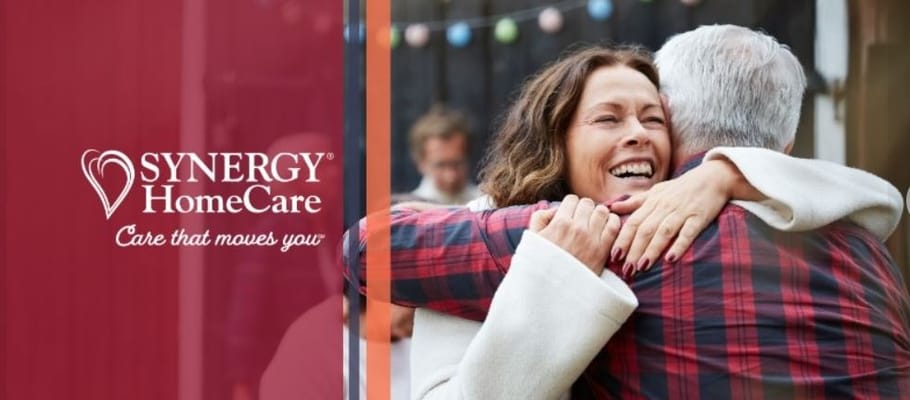 Two people sharing a warm embrace outdoors.