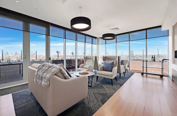 Modern lounge with seating and large windows