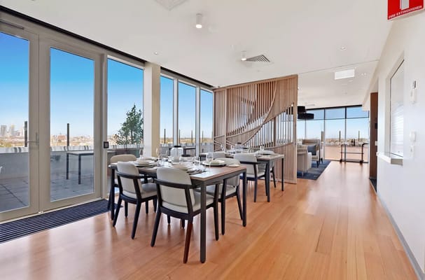 Modern dining area with large windows and city views