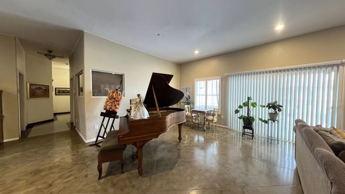 Elegant living room featuring a grand piano and seating area