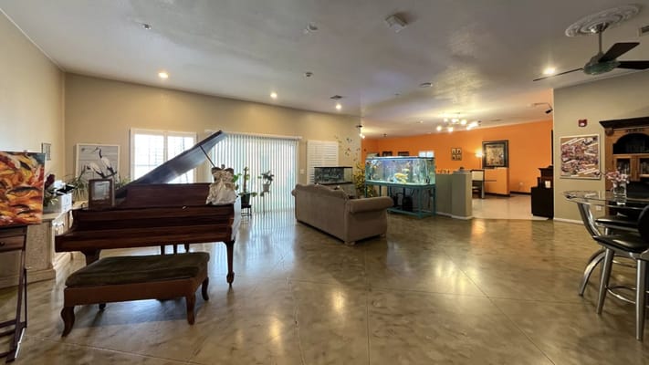 Spacious living room with a piano and aquarium