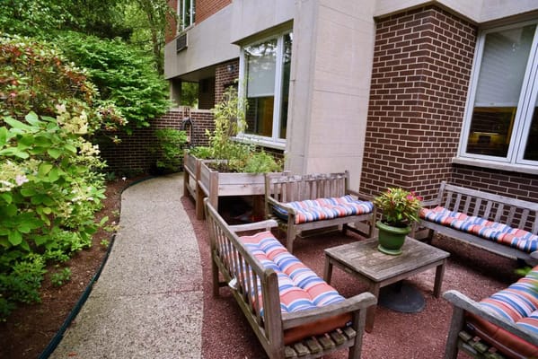 Outdoor seating area with striped cushions and greenery