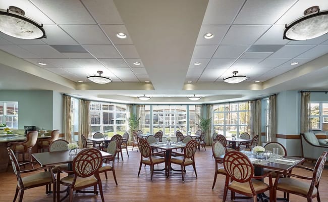 Bright dining room with tables and chairs set for dining
