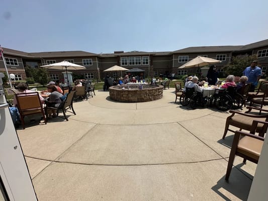 Residents enjoying outdoor dining by the fire pit